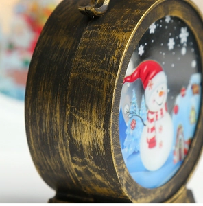 Detail of Christmas lantern with bronze finish showing snowman scene and brushed texture