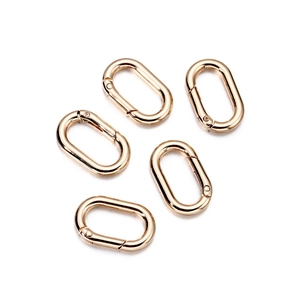 Macro shot of five polished gold oval spring ring gate buckles for DIY bag accessories