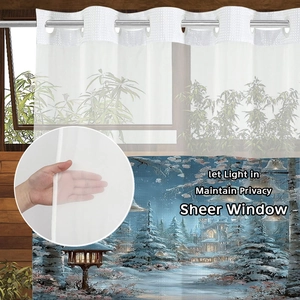 Detail of sheer white fabric and large metal rings on a waterproof shower curtain