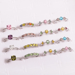Collection of minimalist flower rings with colorful zircon and pearl in a display tray