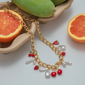 Detailed view of titanium steel pearl necklace with red cherry and fruit charms