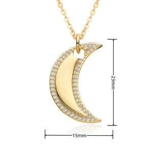 Detail view of 23mm moon pendant necklace with micro-pave crystals in gold finish
