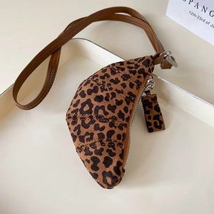 Macro shot of leopard print mini croissant bag detail with zipper and brown strap