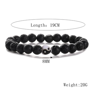 Detail of 19cm black lava stone bead bracelet featuring an 8mm Yin Yang heart charm