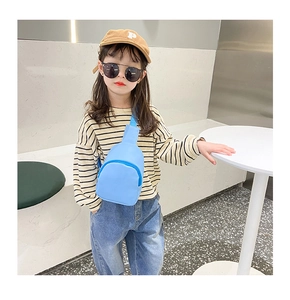 Light blue children crossbody bag shown on a young model for toddler fashion styling