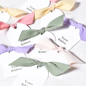 Assorted pastel ribbon bows on display cards featuring mint, lavender, and pink colors