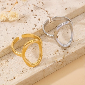 Minimalist organic oval open rings in gold and silver finish on stone display
