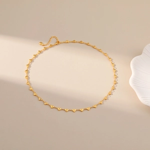 Detailed view of 18K gold plated copper heart link necklace on a beige minimalist background