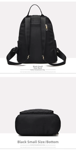 Detail view showing adjustable nylon straps and metal zippers of the black backpack