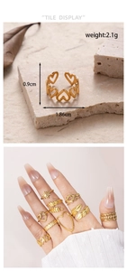 Detail view of gold stainless steel rings featuring leaf and heart motifs for women