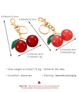 Detailed view of red cherry pendants showing zinc alloy hooks and 12.5cm size dimensions