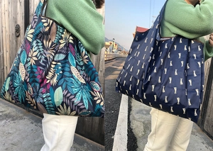 Detail showing tropical leaf and rabbit polka dot print patterns on portable tote bags