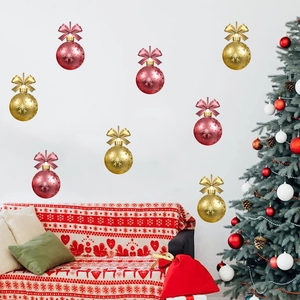 Detail view of red and gold Christmas ball wall stickers with festive snowflake patterns