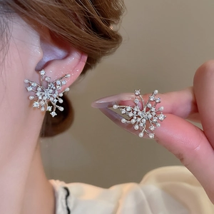 Detailed view of silver zircon snowflake earrings with elegant white pearl accents