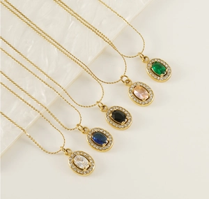 Macro detail of gold stainless steel necklaces with colorful oval zircon stone pendants