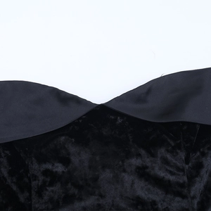 Detail of black velvet texture and satin edge on the off-shoulder neckline area