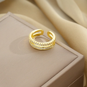 Detail of gold double-layered open ring with sparkling round and rectangle zircon stones