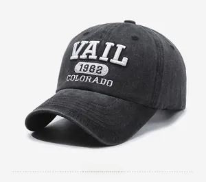 Detail of white 3D embroidery showing VAIL 1962 COLORADO on washed denim baseball cap