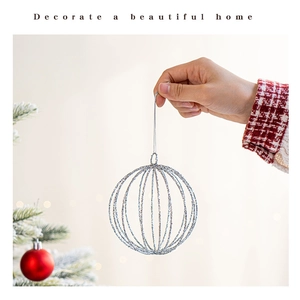 Close-up of silver hollow Christmas ball ornament with glitter finish and hanging string