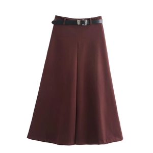 Detailed view of deep brown A-line maxi skirt with black leather belt and silver buckle