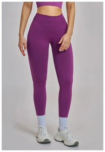 Detail of high-waisted seamless dark purple yoga leggings and matching sports bra set