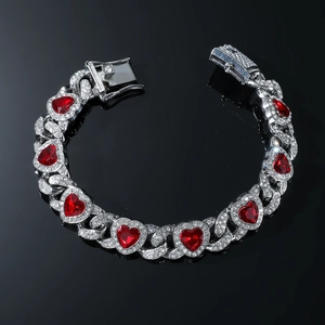Detail of silver Cuban chain bracelet with red heart gems and sparkling rhinestones