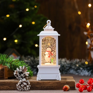 Detail of white Christmas lantern with snowman inside and festive background light