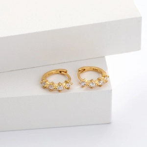 Detail view of 925 sterling silver gold hoop earrings with sparkling zircon gemstones