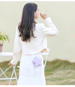 Detail of lavender star-shaped PVC crossbody bag with elegant gold chain strap
