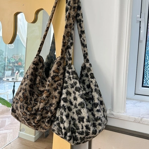 Detailed view of plush leopard print crossbody bags in dark brown and charcoal grey textures