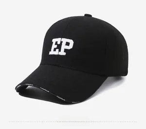 Detail of black wool baseball cap featuring white EP embroidery and fashion brim text