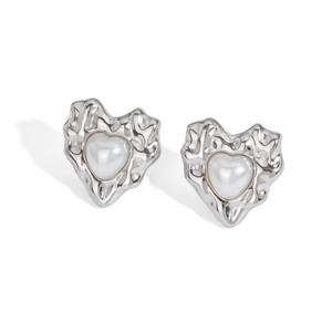 Close-up of silver oval stud earrings with irregular lava texture and heart pearl inlay