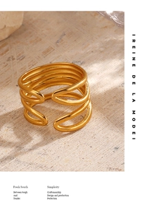 Detail of 18K gold-plated multi-layer minimalist ring on a textured stone background