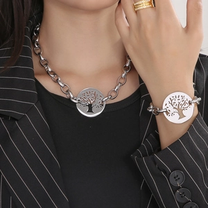 Detail of Tree of Life pendant set with chunky silver chain necklace on female model