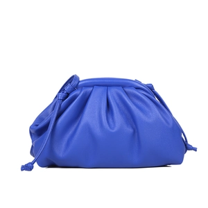 Minimalist bright blue dumpling pouch bag in soft lychee grain leather with knot strap
