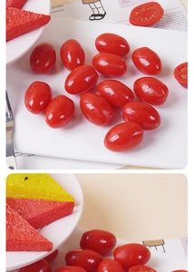 Detailed view of realistic red cherry tomato models and sliced fruit props on a plate