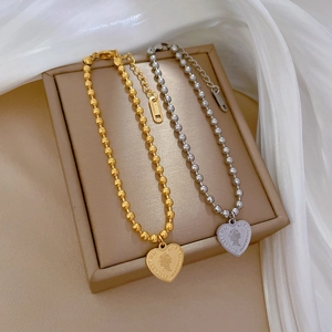 Titanium steel necklaces with heart coin pendants in gold and silver finishes