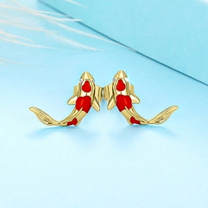 Detail of koi fish stud earrings with red enamel coating and sparkling zircon stones