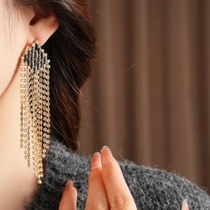 Macro detail of vintage rhombic tassel earrings with black crystals and silver pins