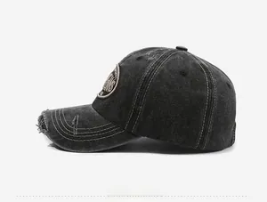 Close-up of distressed baseball cap showing washed denim texture and embroidered patch