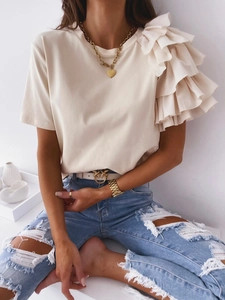 Detail of layered ruffle shoulder design on a cream short sleeve round neck t-shirt