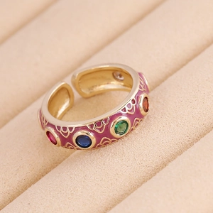 Retro gold copper ring with purple enamel and colorful zircon stones on beige display