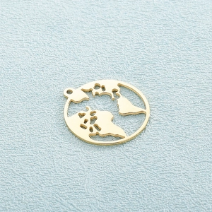 Golden stainless steel circular hollow world map pendant on light blue textured background