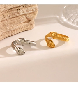 Detailed macro shot of snakeskin texture on gold and silver coiled snake rings