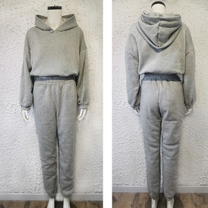 Detail view of grey hooded sweatshirt and jogger set on mannequin showing front and back