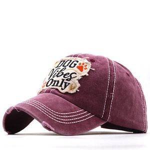 Detail of washed cotton baseball cap with DOG Vibes Only embroidery and distressed brim