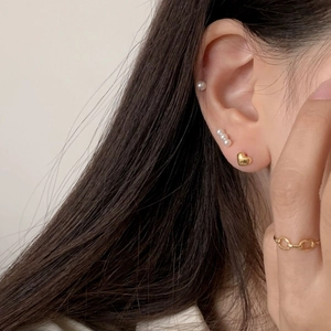 18K gold plated heart studs and pearl earrings set shown on model with chain ring