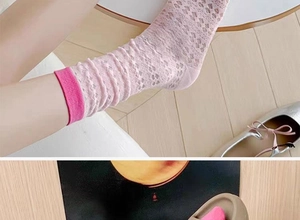 Close-up of light pink breathable mesh crew socks for women featuring hollow-out texture