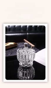 Close-up of geometric diamond relief texture on clear glass storage jar with lid