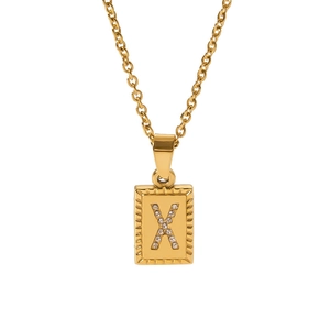 Detailed macro view of an 18k gold plated rectangle pendant with a zircon letter X